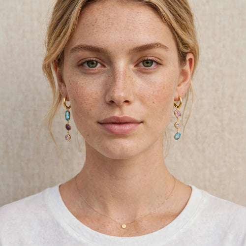 Model wearing the Aurora Prism Mismatched Drop Earrings