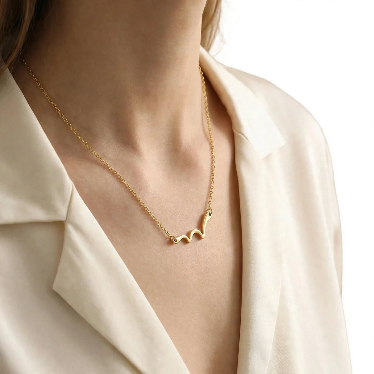 Model wearing the Marina Wave Pendant Necklace, side view