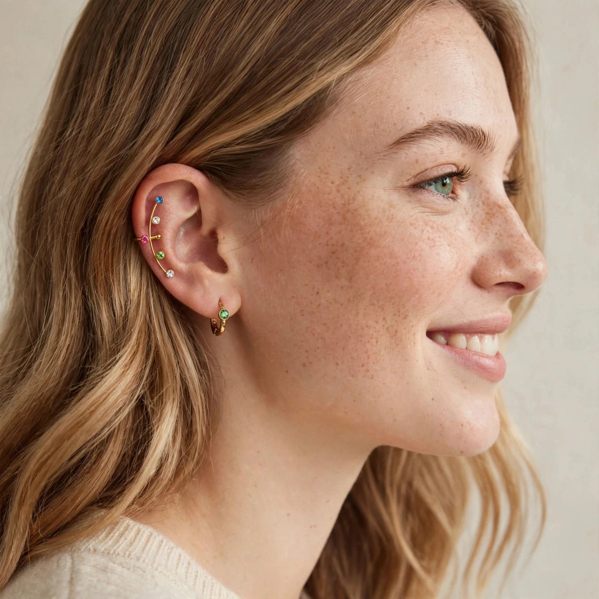 Aura Rainbow Ear Cuff worn on a model's ear