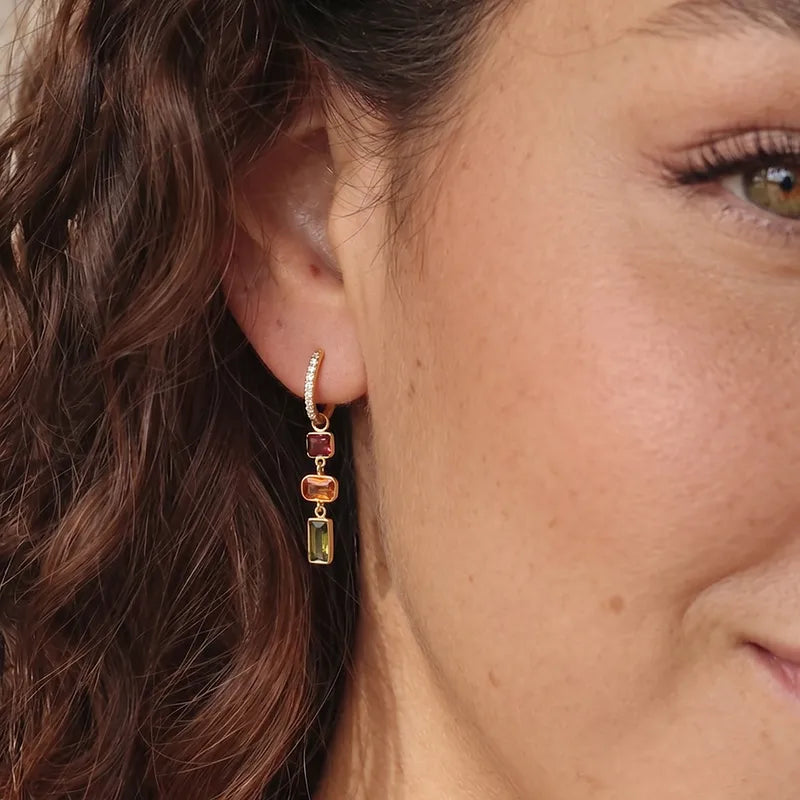 Model wearing the Elnora Ember Falls Huggie earrings